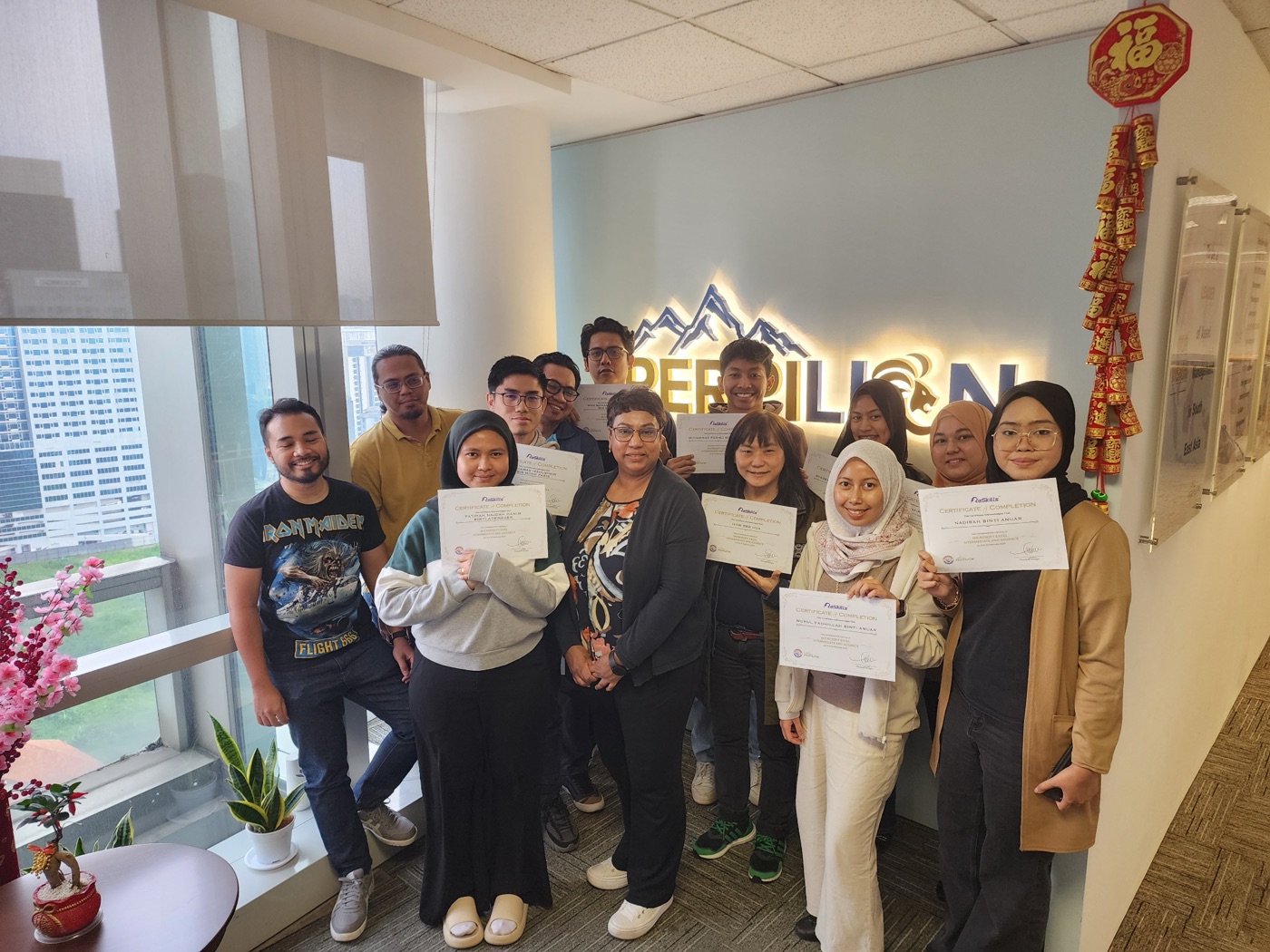 Corporate training workshop with diverse Malaysian team members collaborating